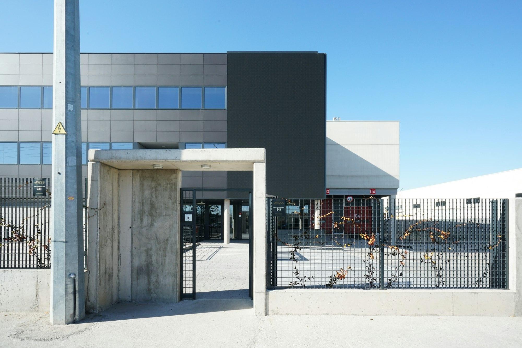 Modern commercial facility with security gate and access control